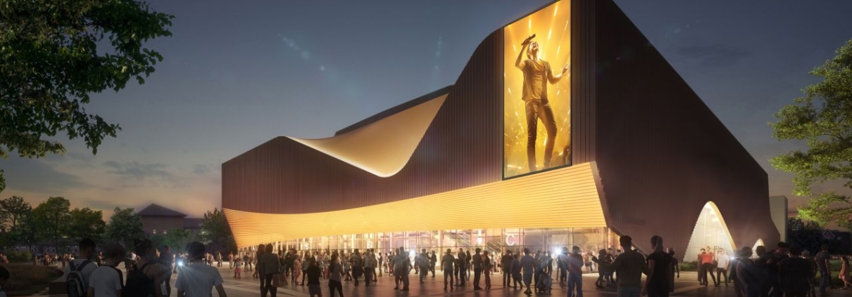 Modern indoor arena at night with city backdrop