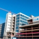 NHS hospital construction site with cranes and workers