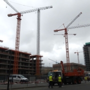 UK construction site with workers and cranes, subdued activity
