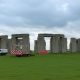 Stonehenge monument with construction barriers and equipment nearby.