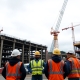UK steelworkers at busy construction site with cranes