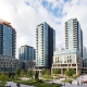 Modern Bayswater mixed-use development with cranes and buildings.