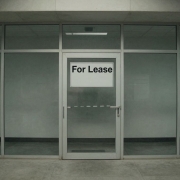 Empty office building with a 'For Lease' sign.