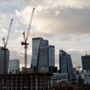 London skyline with construction cranes and unfinished buildings.