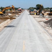 New concrete road construction with heavy machinery.