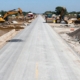 New concrete road construction with heavy machinery.